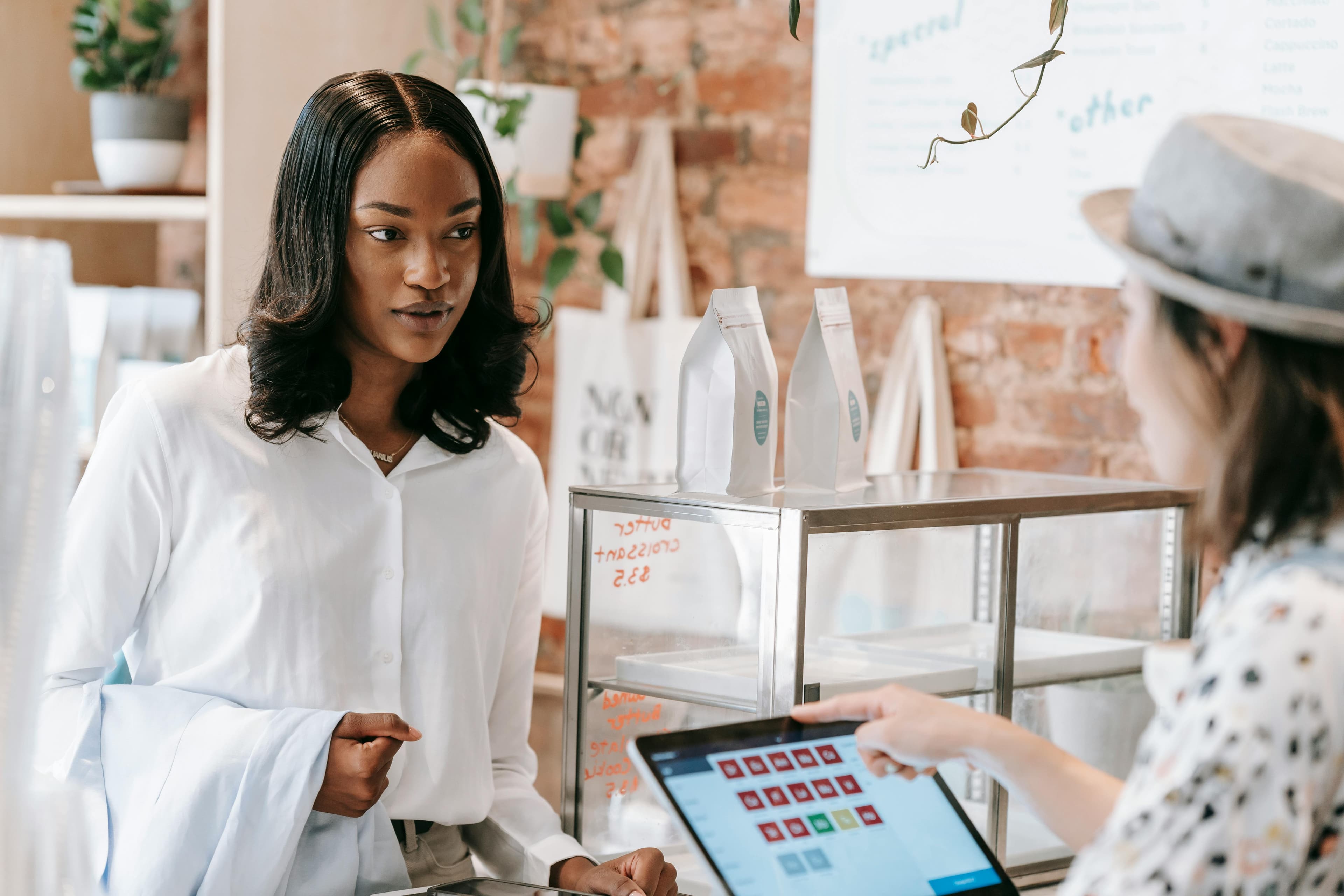 A customer interacts with a cashier at a trendy shop counter